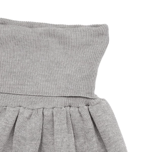 Macro detail of high-quality grey ribbed knit fabric with precise pleats and stitching