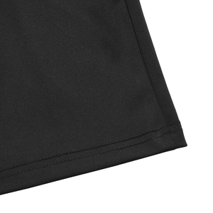 Detailed close-up of double-stitched hem on black knitted elastic fabric of dress