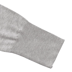 Close-up of the ribbed cuff detail on light grey knitted long sleeve crop top