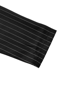 Close-up of black and white striped sleeve cuff showing fine twill fabric and stitching