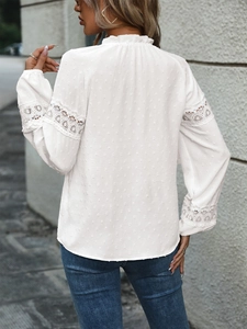 Detail of white blouse with lace inserts, Swiss dot fabric and ruffled stand collar