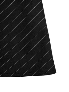 Detailed macro view of the black and white striped fabric texture and hem stitching on the dress