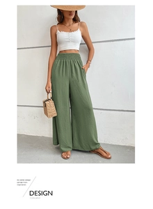 Detail of high-waisted olive wide leg pants with elastic waist and ribbed texture