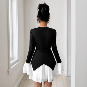 Elegant black and white contrast dress with long sleeves and layered ruffle hem