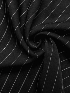 Macro shot of elegant black pinstripe fabric showing texture and drape of the dress
