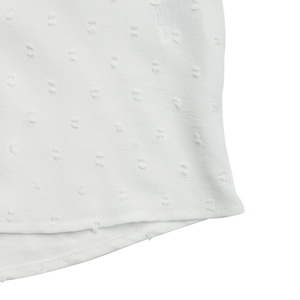 Detail shot of white Swiss dot fabric texture and neat stitching on a lace blouse
