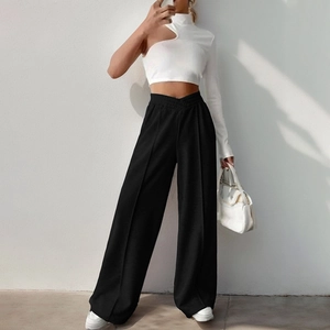 Women's white one-shoulder cutout crop top and black high-waisted wide-leg trousers set