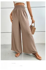 Detail of high waist pleated elastic waistband on brown wide leg linen trousers