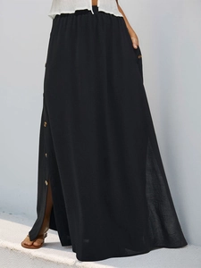 Detailed macro view of side buttons and texture on a long black maxi skirt for women