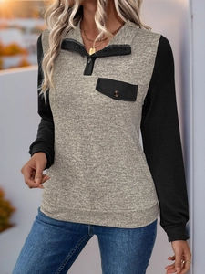 Detail eines Colorblock-Sweatshirts mit Polokragen und kontrastierenden schwarzen Ärmeln