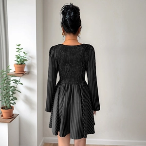 Elegant long-sleeved black and white striped mini dress with a pleated back design