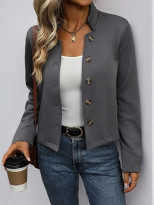Close-up of women's dark grey textured jacket showing single-breasted marble buttons