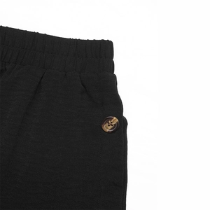 Macro detail of elastic waist with tortoise button on black cotton linen casual skirt