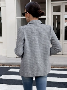 Detail shot of black and white fine plaid blazer with textured tweed fabric and lapel collar