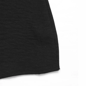 Detailed close-up showing the high-quality stitching and texture of the black maxi skirt hem
