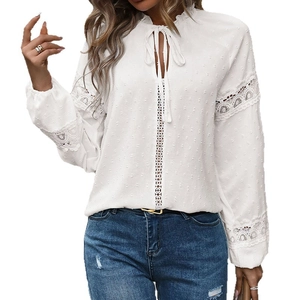 Elegant white Swiss dot blouse with lace inserts and ruffled neck tie detail
