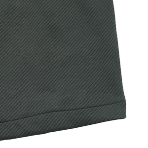 Close-up of the fine twill texture and neat stitching on the dark grey jacket hem