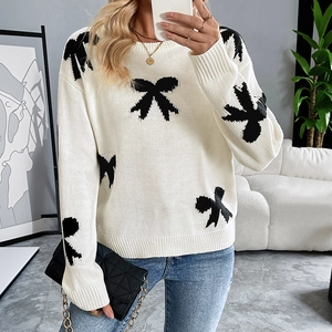 Elegant cream knit sweater with black bow patterns and round neck for women