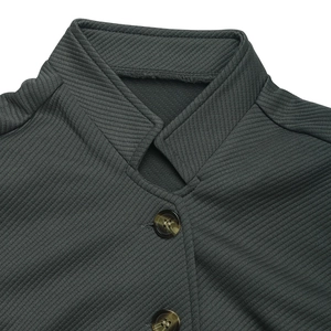 Close-up of charcoal gray jacket featuring textured diagonal twill and stand collar detail