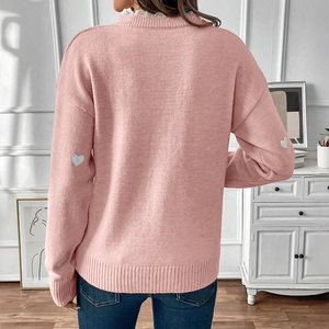 Pink knit sweater with gray heart patches and delicate white lace collar detail