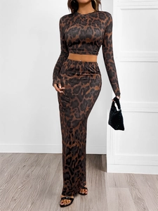 Close-up of leopard print two-piece set featuring long-sleeve crop top and maxi skirt