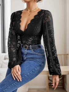 Close-up of elegant black floral lace bodysuit with V-neckline and scalloped edges