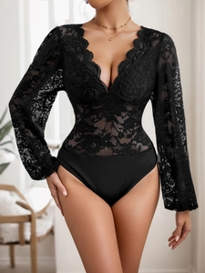 Close-up of the elegant black lace bodysuit featuring intricate V-neck floral patterns
