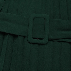 Detail view of dark green pleated dress featuring a matching fabric-covered rectangular belt buckle
