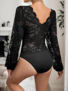Close-up of elegant V-neck back design with delicate lace trim on a black long sleeve bodysuit