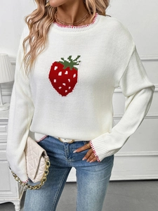 Detail of red strawberry pattern and contrast stitching on white knitted sweater