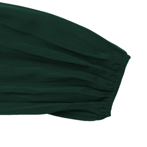 Detail of dark green dress showing elasticated cuffs and textured twill fabric detail