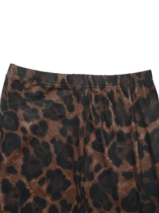 Close-up of leopard print leggings featuring elastic waistband and stretchable fabric