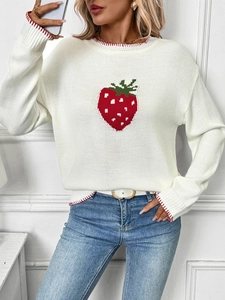 Detail of strawberry jacquard knit sweater with striped cuffs and soft texture