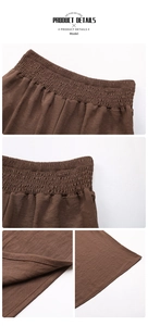 Detail view of high elastic pleated waistband on brown wide-leg flowy trousers