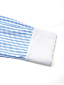 Detail of blue and white striped shirt showing crisp white cuffs and neat stitching