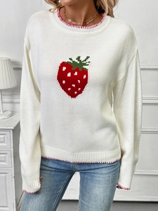 Detail of red strawberry knit pattern and red stitching on a white crewneck sweater