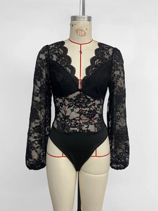 Close-up of floral lace texture and deep V-neckline on this black long-sleeve bodysuit