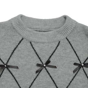 Detail of grey crewneck sweater featuring argyle patterns and bow accents with pearls