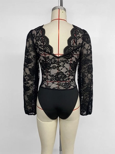 Detail of elegant black floral lace bodysuit with deep V-back and scalloped lace trim