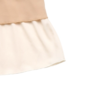 Detail of layered hemline showing camel knit fabric and cream pleated fabric contrast