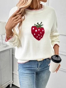 Detail of white knit sweater featuring red strawberry pattern and striped ribbing cuffs