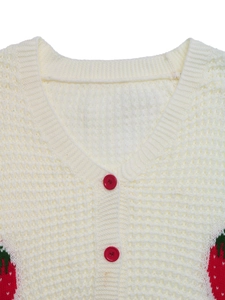 Detail of V-neck cardigan featuring red strawberry jacquard and matching buttons
