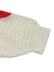 Close-up of ribbed knit cuffs and red strawberry jacquard pattern on a white sweater