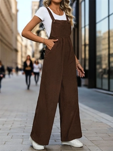Detail of vintage brown corduroy overalls with metal buckles and side pockets