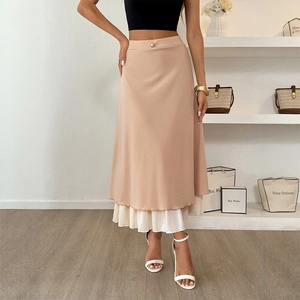 Chic beige layered midi skirt featuring pleated hem and decorative pearl waist button