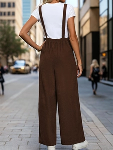 Detailed back view of vintage dark brown corduroy overalls with wide leg drape effect