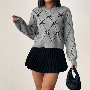 Gray crewneck knit sweater with black bow accents and white pearls on diamond patterns