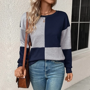 Detail of navy and grey color-block knit sweater with diagonal ribbed texture