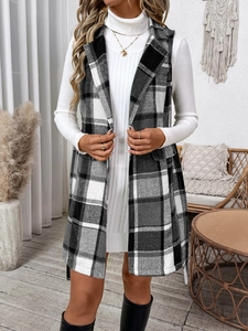 Close-up of the black and white plaid vest with notched lapels and decorative pockets