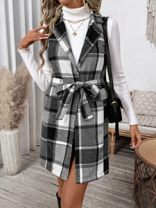 Detail of a long plaid vest with a lapel collar and waist tie for layering